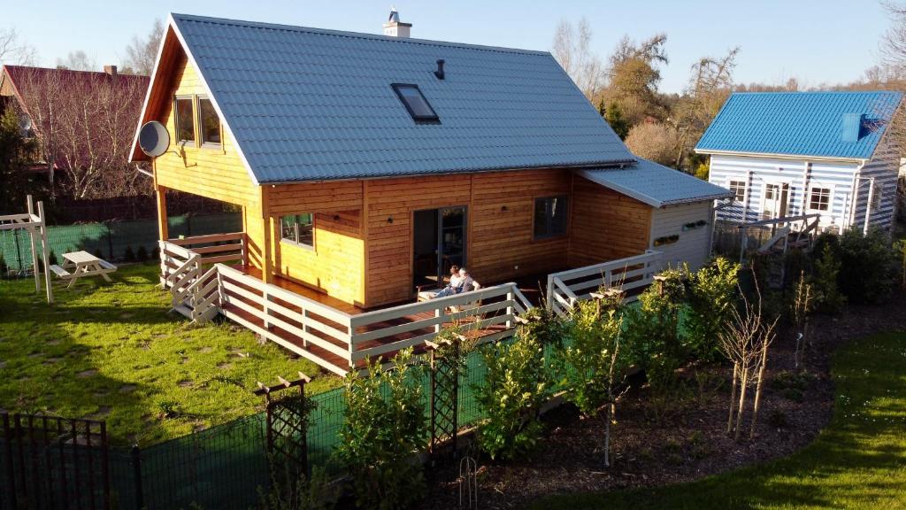 a tiny house with a dog sitting in the doorway at Willa Arkadia Kopalino in Kopalino