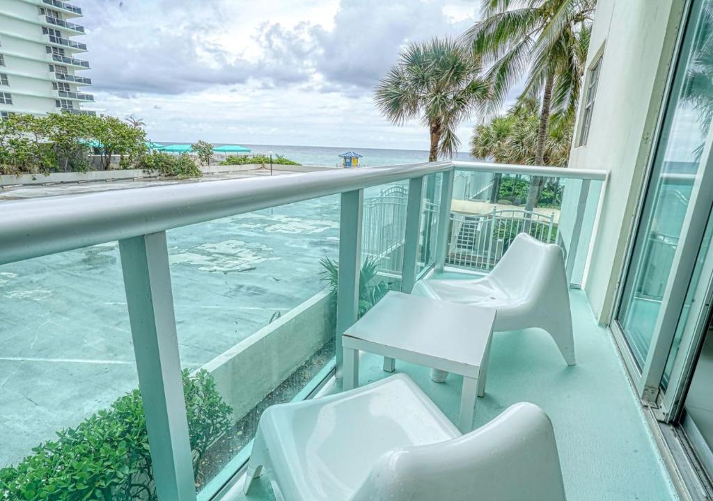 a balcony with chairs and a view of the ocean at Miami Hollywood 2 Bedroom 2 Bath Condo 002-22bmar in Hollywood