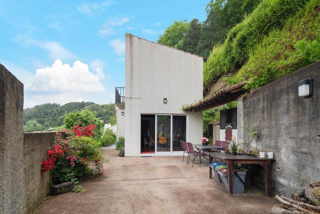an external view of a house with a table and chairs at Paradise House Furnas in Furnas