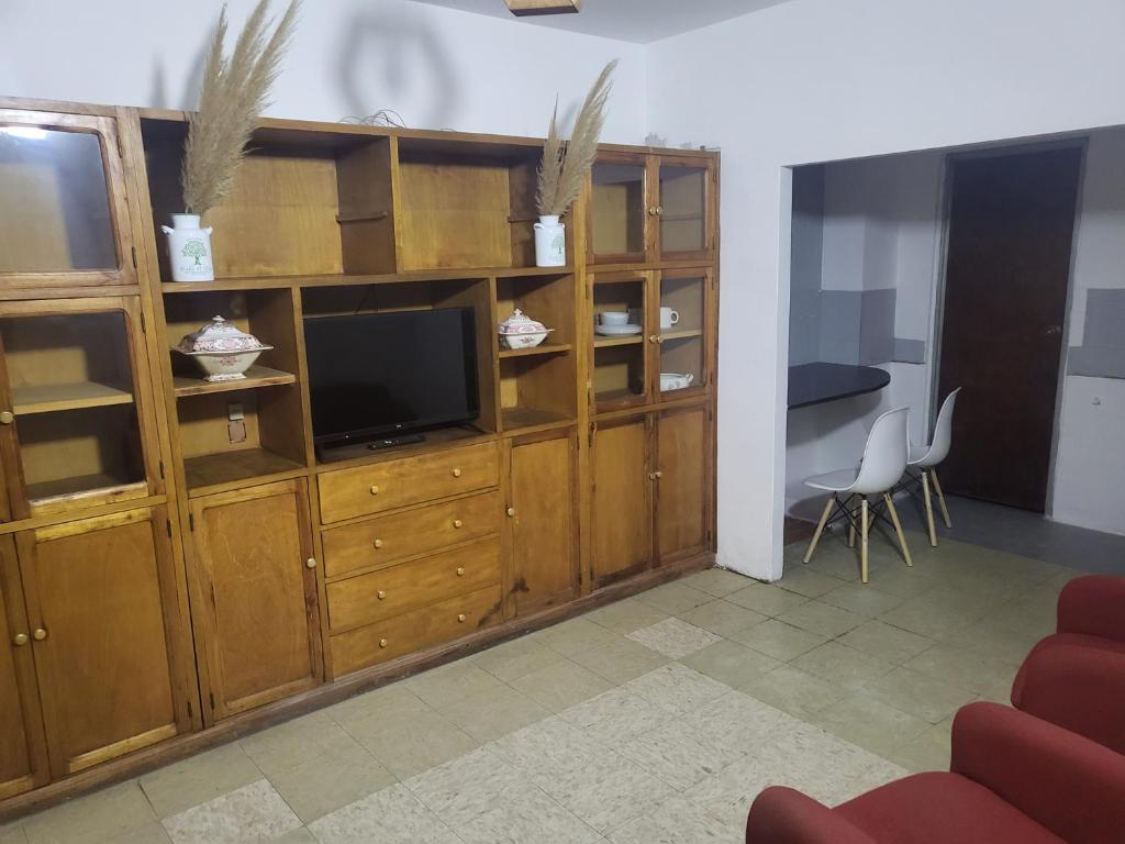 una sala de estar con un gran centro de entretenimiento de madera con TV en SLC San Martín 1 en San Luis