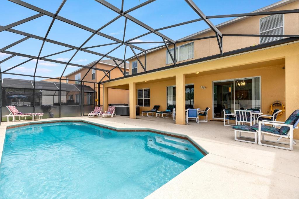 a large swimming pool with a glass roof at Tiger Lilly at Ellis Exclusive Villas in Kissimmee