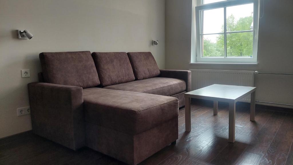 a living room with a couch and a table at Comfy room near city centre in Tallinn