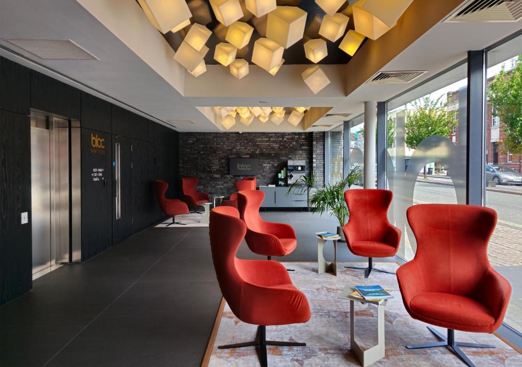 a row of red chairs in a waiting room at Bloc Hotel Birmingham in Birmingham