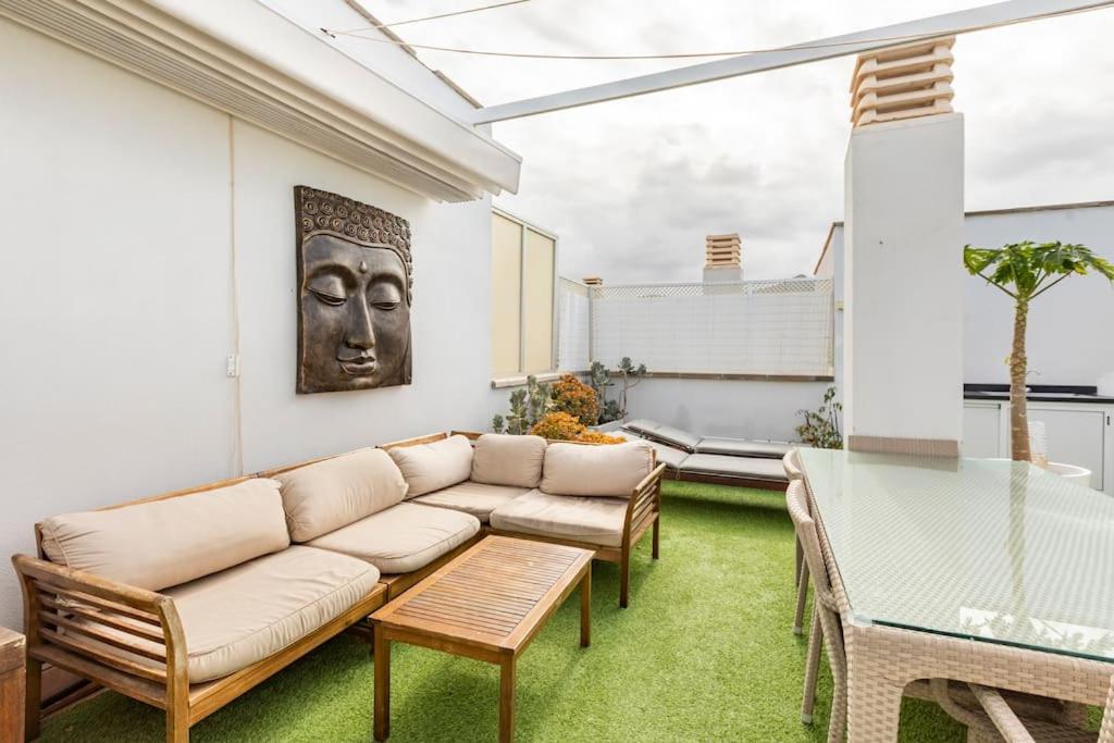 a living room with a couch and a table at Buddha penthouse solarium+pool in Gáldar