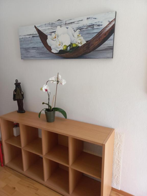 ein Zimmer mit einem Holzregal und einem Gemälde an der Wand in der Unterkunft Tripalme Izola in Izola
