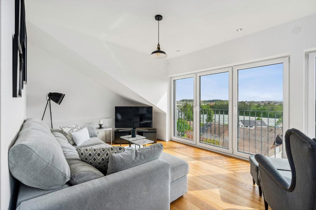 a living room with a couch and a tv at Ferienhaus BergerHalde in Friedrichshafen