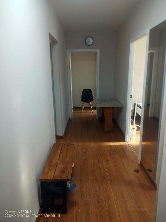 a hallway with a wooden table and a desk in a room at tsogoo's geust house in Ulaanbaatar