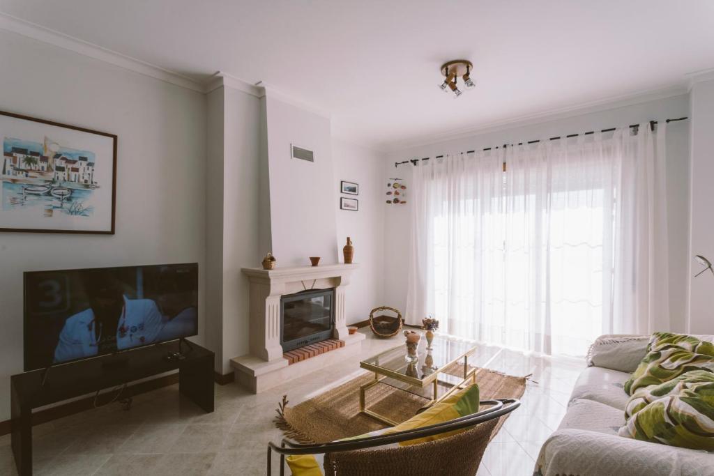 a living room with a couch and a fireplace at Best Houses 84 - Mar Salgado in Ferrel