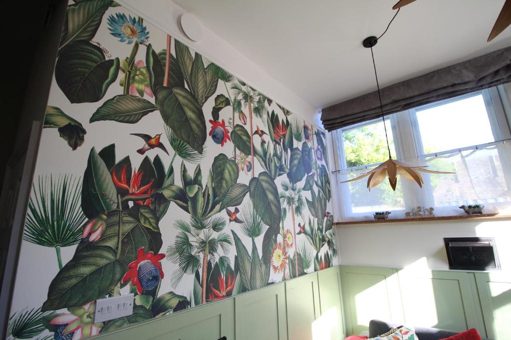 a wall with a mural of flowers and plants at The Old Schoolhouse in Whitstable