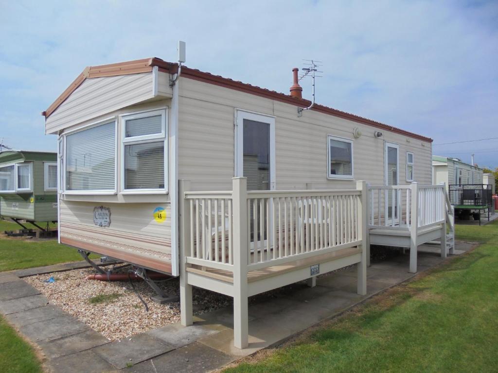 a tiny house with a porch and two decks at 6 Berth Sealands Ingoldmells Central heated (Carlton) in Ingoldmells