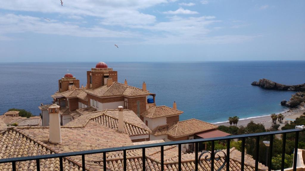 a building on the beach with the ocean behind it at ADNANIa 2023 in La Herradura