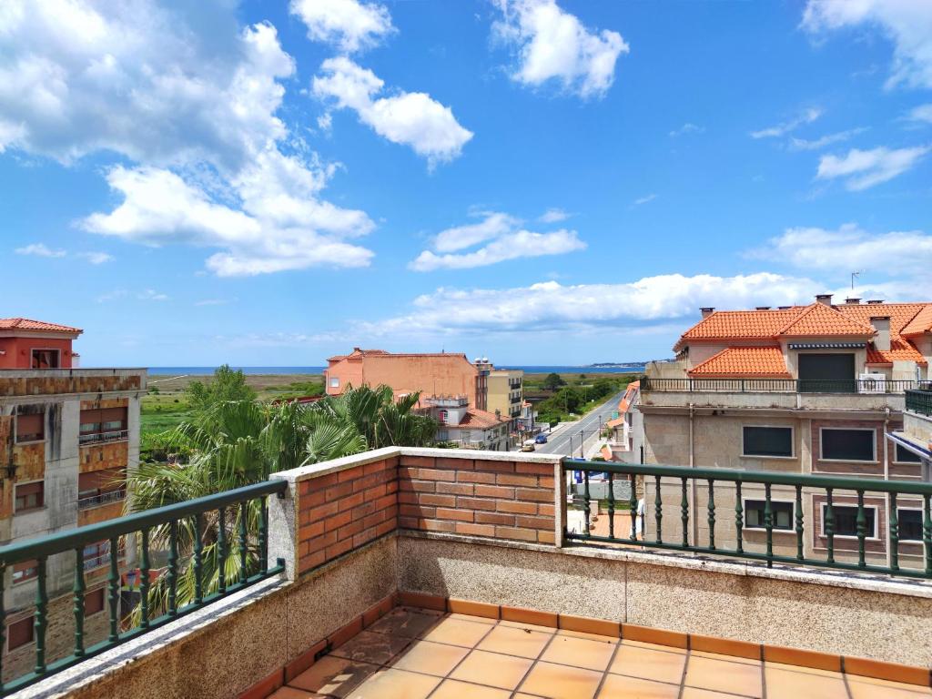 a balcony with a view of a city at Desconectaengalicia Ático La Lanzada in A Lanzada