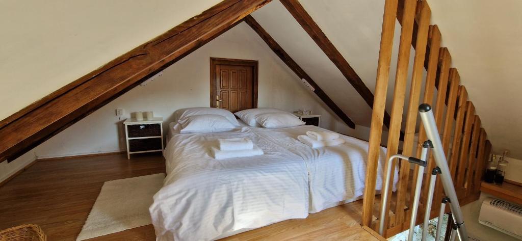 a bedroom with a large bed in a attic at Studio apartman Tomi - seaview in Vis