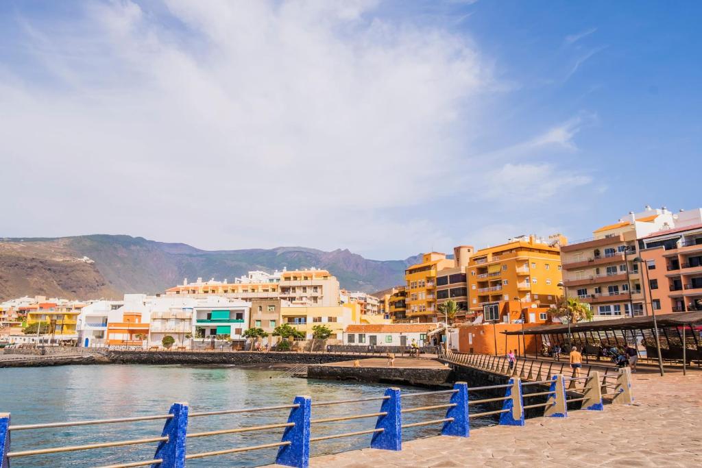 a group of buildings next to a body of water at Live Puertito Almirante in Puertito de Güímar
