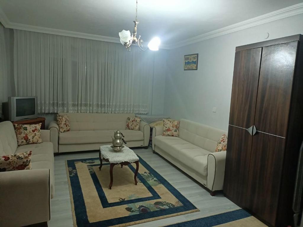 a living room with couches and a table at Kadı Home 