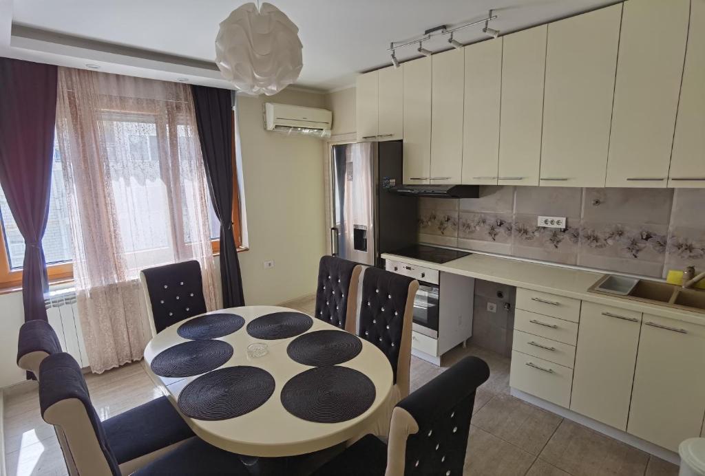 a kitchen with a table and chairs in a room at Kalina Apartment in Dušanovac (historical)