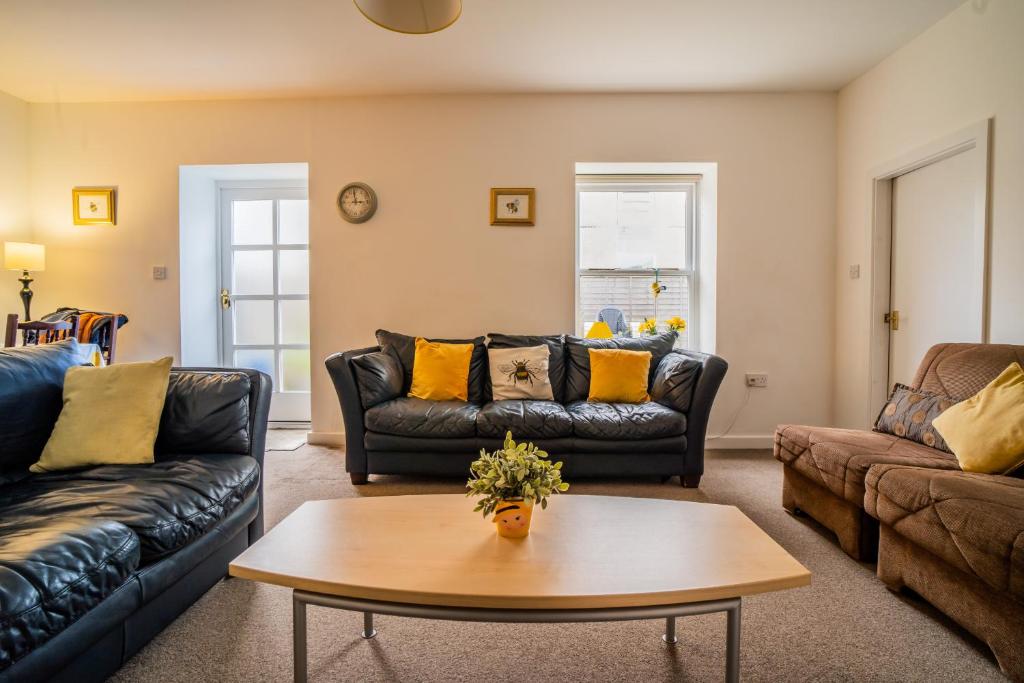 a living room with couches and a coffee table at The Torrs Apartments New Mills in New Mills