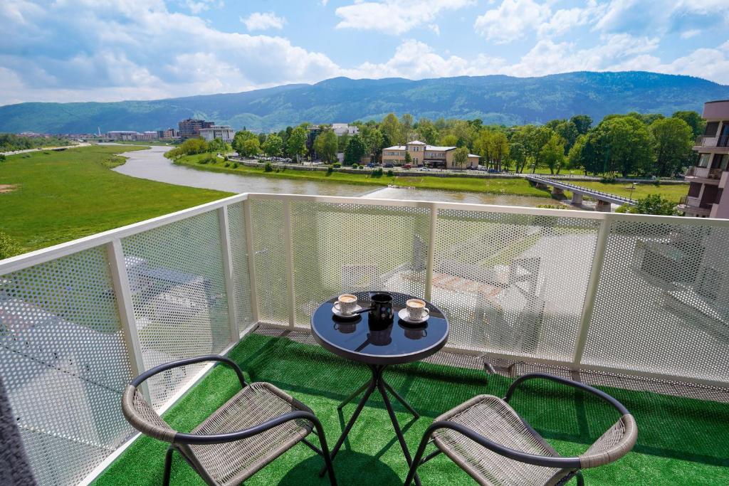 a balcony with a table and chairs on a balcony at Happy apartment Ilidža in Sarajevo