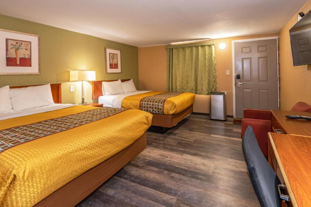 a hotel room with two beds and a desk at Town Motel in Forks