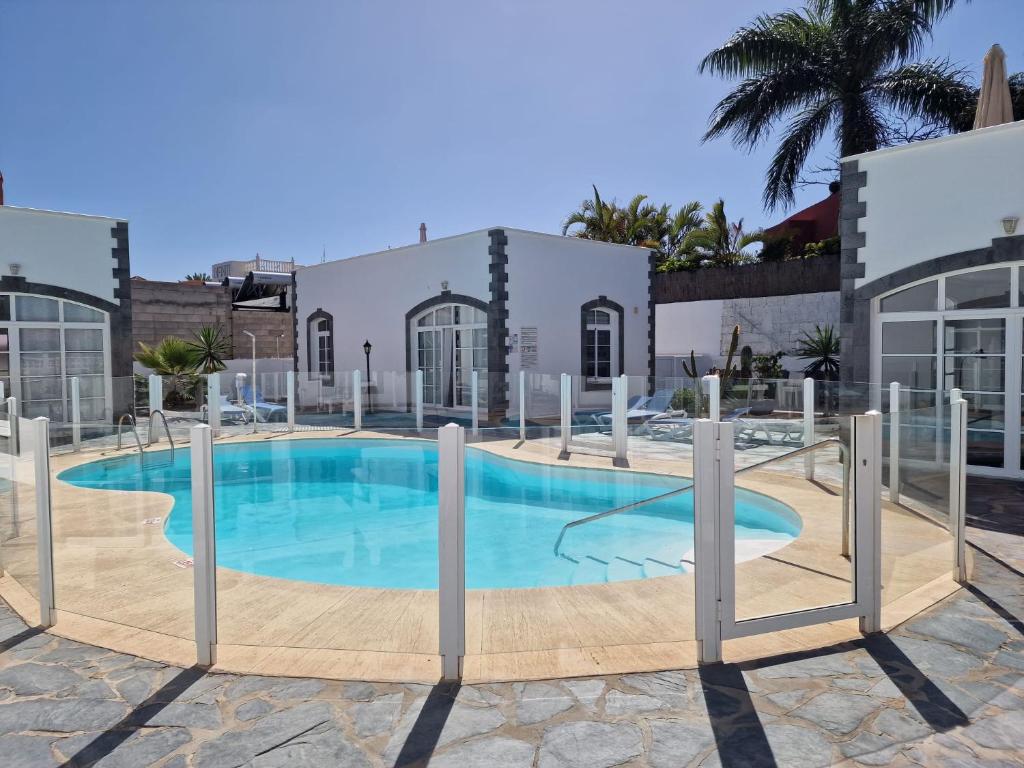 a large swimming pool in a building at Nora Retreat (Fully Renovated) in Corralejo