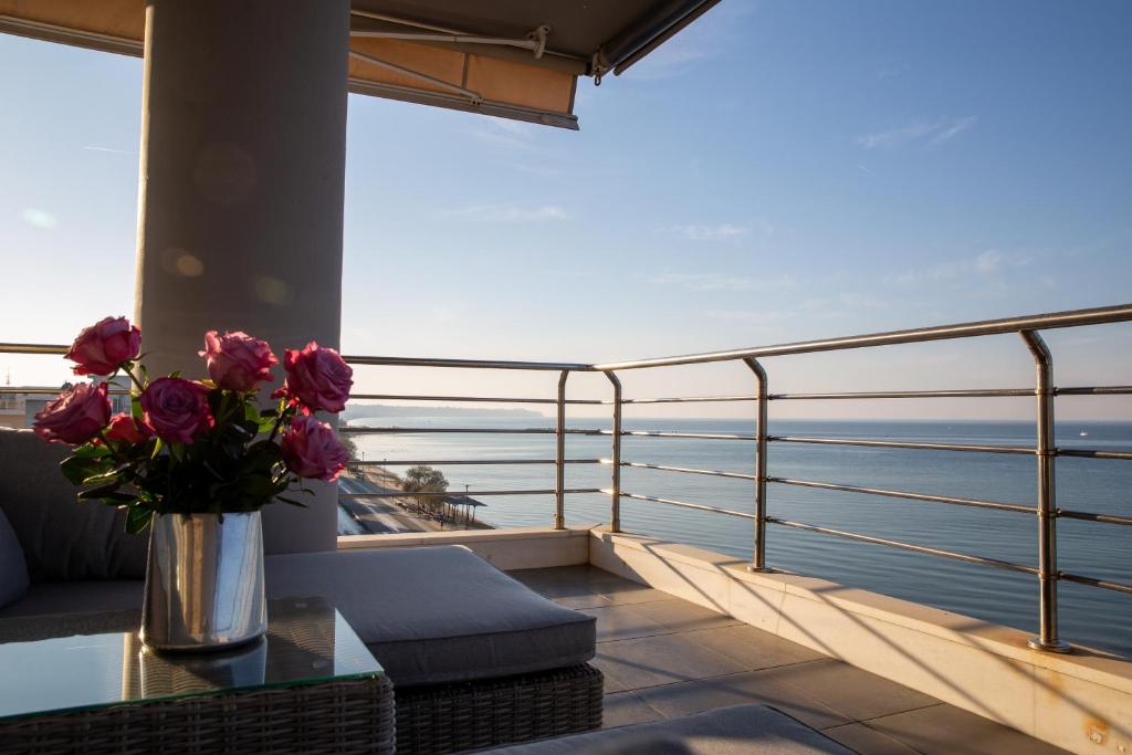 a vase of flowers sitting on a table on a balcony at Salty Breeze Premium Stay in Perea