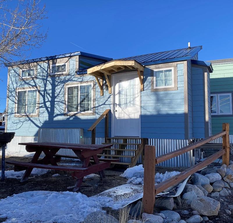 a tiny house with a picnic table in front of it at Tiny House Leadville Colorado in Leadville