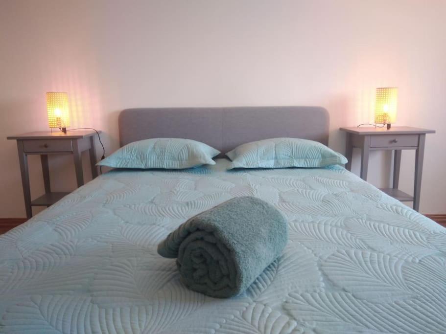 a large bed with two nightstands and amitt at Navigation House in Sesimbra