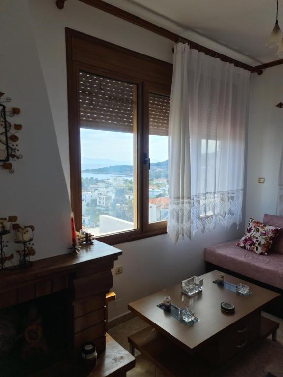 a living room with a couch and a window at Votsi Seaview in Alonnisos Old Town