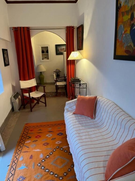 - une chambre avec un lit et un salon dans l'établissement Riad SASHA, à Marrakech