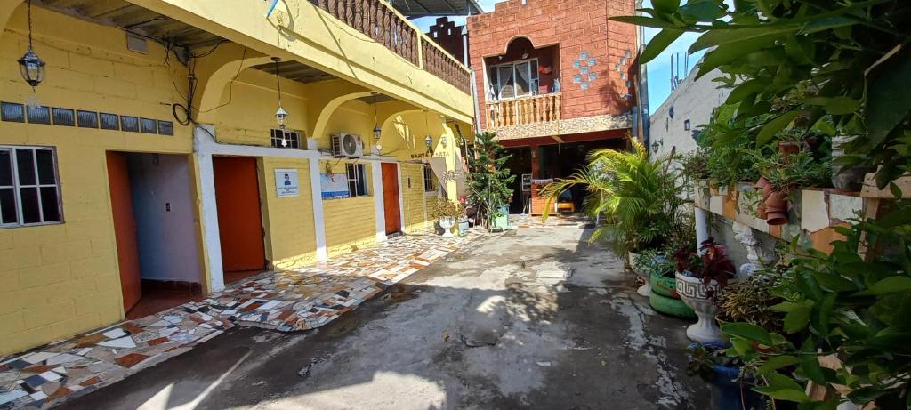 an alley with buildings and plants on the side at Hostal Santa Marta in La Unión