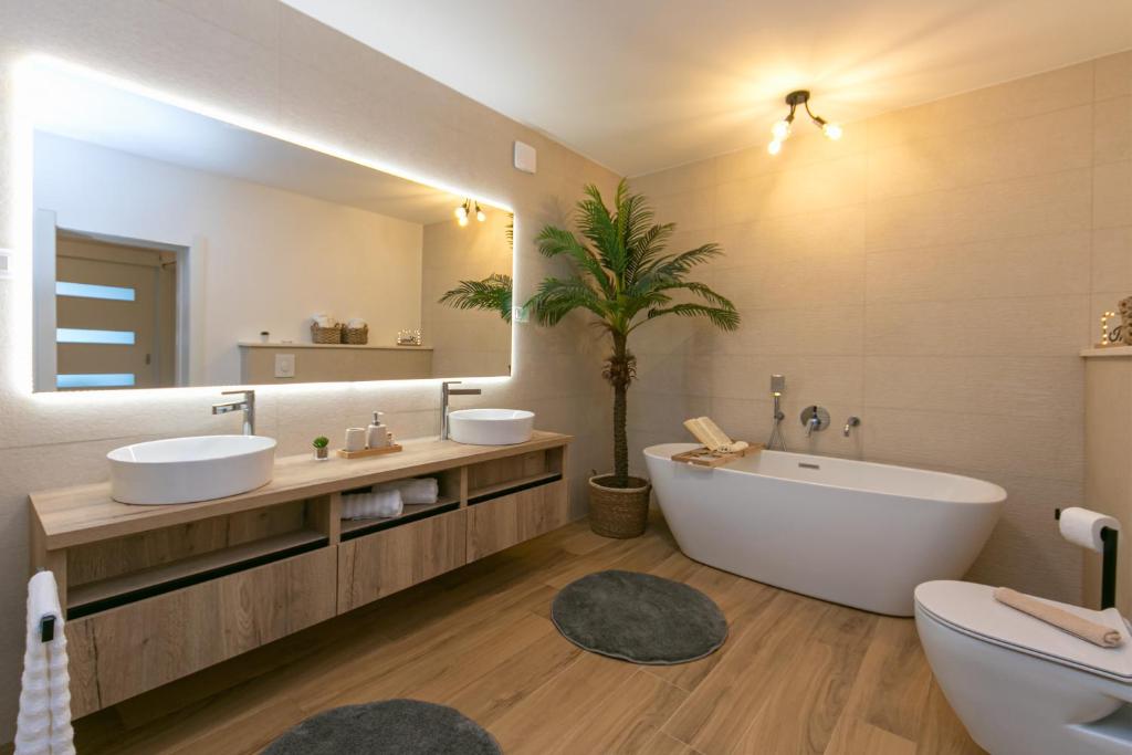 a bathroom with two sinks and a large mirror at Apartment Vidra in Brela