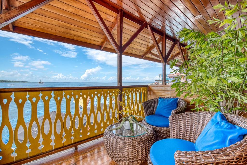 a balcony with chairs and a view of the ocean at Hotel Bocas del Toro in Bocas del Toro
