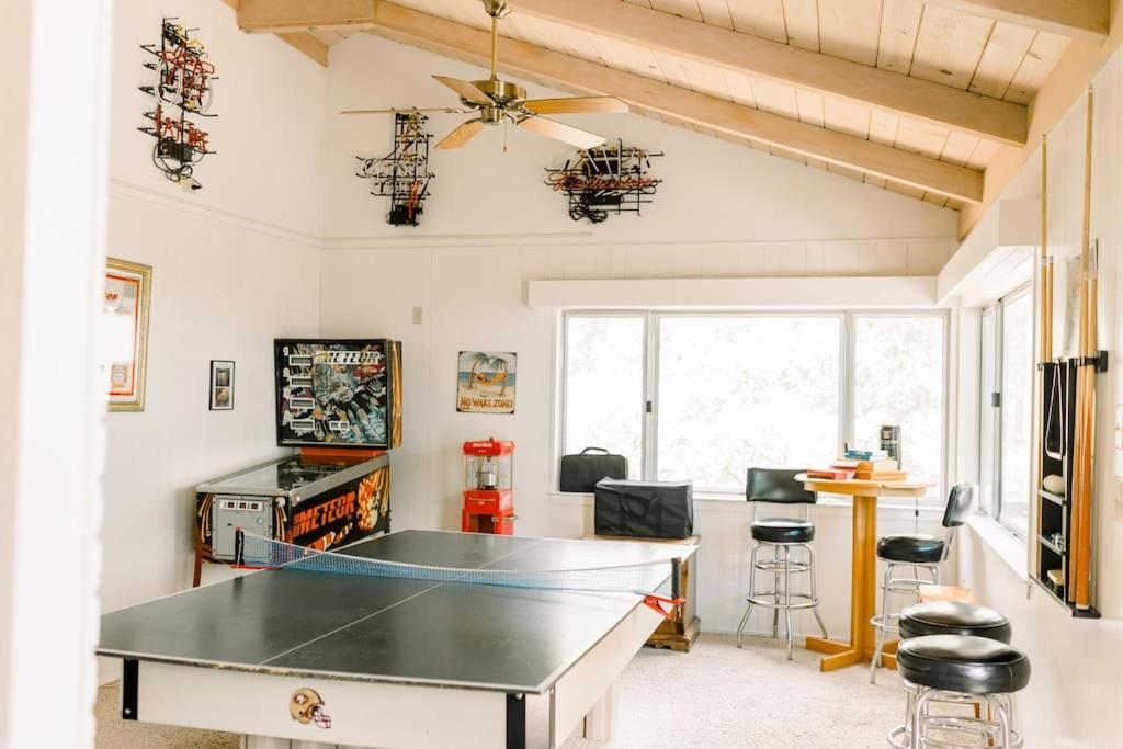 a ping pong table in a living room with a ceiling at Adventure Lodge - Moreno in Bass Lake