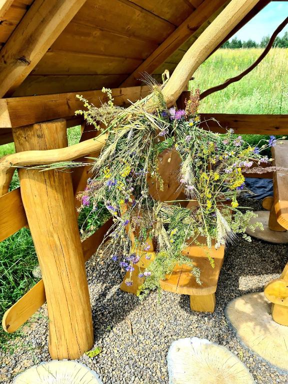 a wooden table with a bunch of flowers on it at Cuda Wianki in Zdów