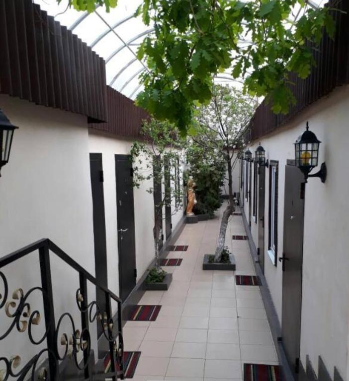 a woman walking down a walkway in a building at Гостиница Энглер в Хромтау in Khromtaū