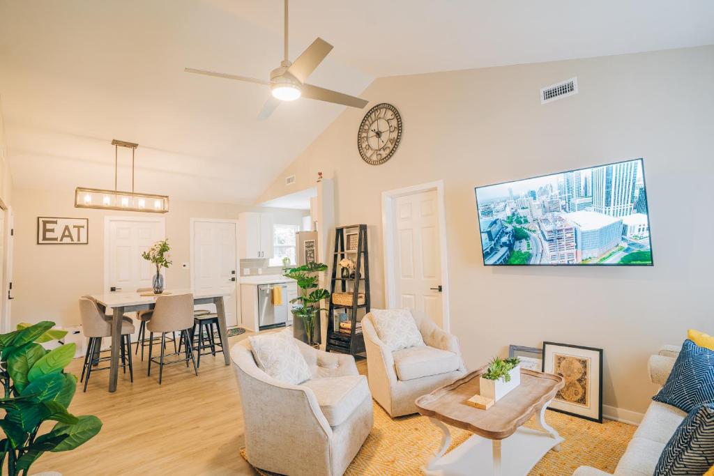 a living room with a clock on the wall at City Retreat - 4 Bedroom Oasis with King & Private Yard near Downtown in Charlotte
