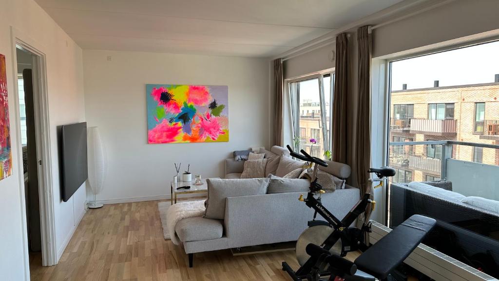 a living room with a couch and a chair at Quiet 3BR 15min from metro/city in Copenhagen