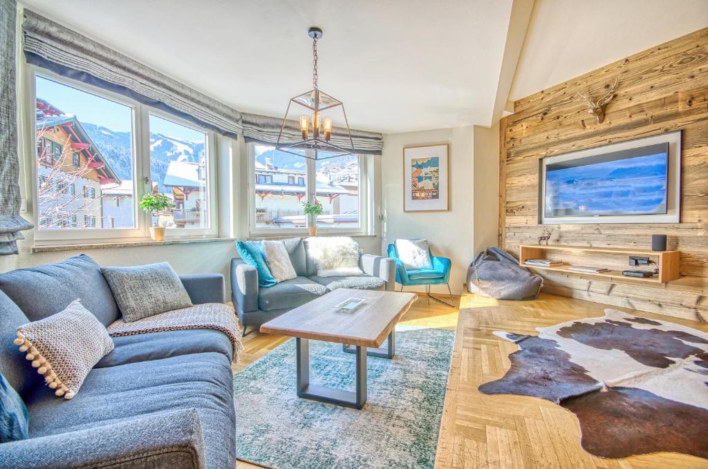 a living room with a couch and a table at Apartment Antonia - by Alpen Apartments in Zell am See