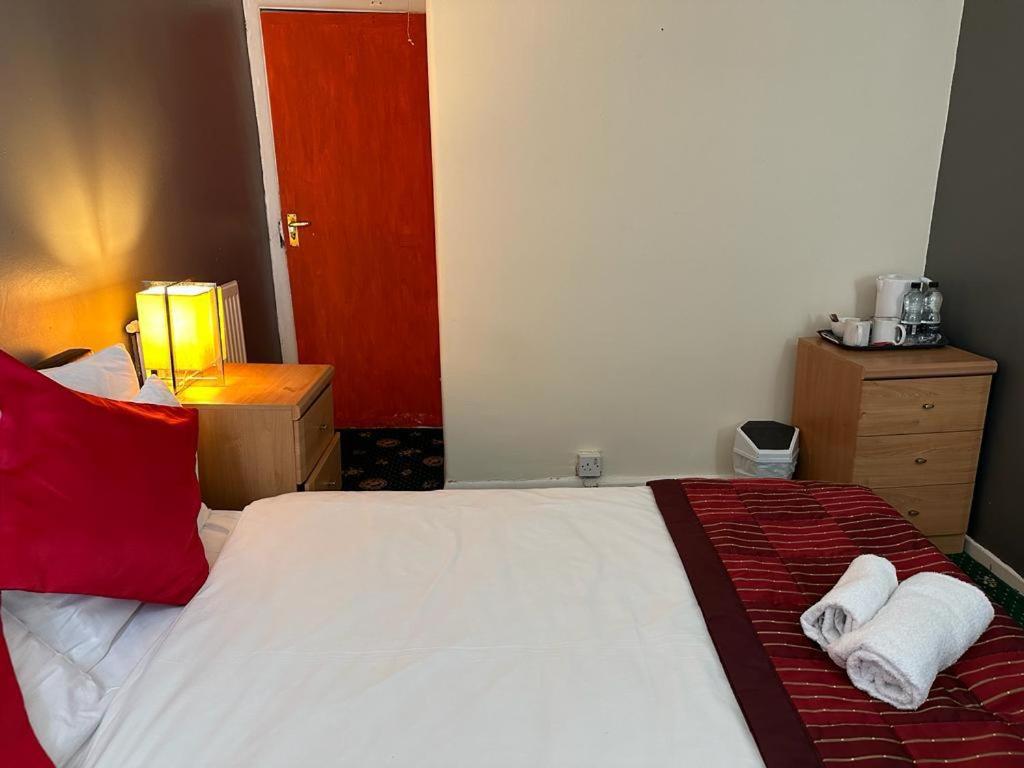 a bedroom with a bed with two towels on it at Northern Pearl Hotel in Blackpool