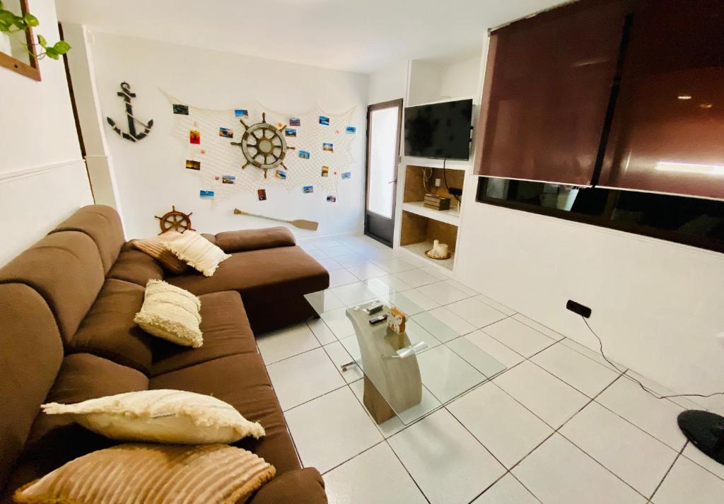 a living room with a couch and a table at CASA ATLANTICO in Puerto del Carmen