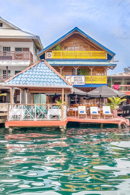 a resort on the water with chairs and tables at Hotel Bocas del Toro in Bocas del Toro