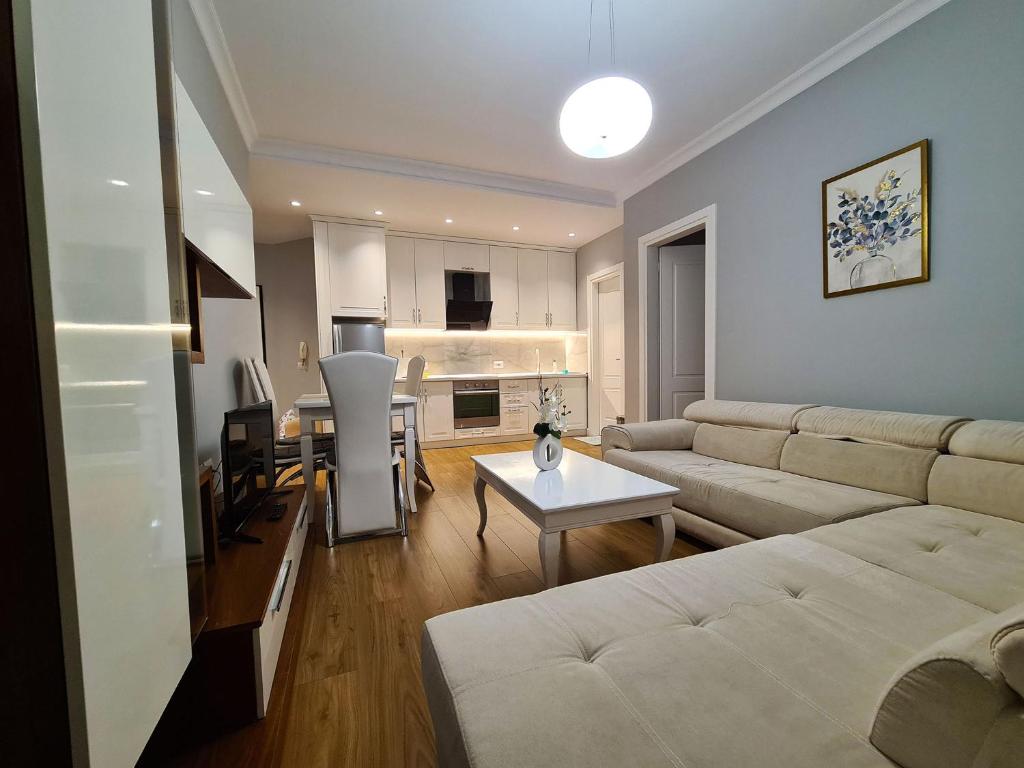 a living room with a couch and a table at Comfort Apartment Tirana Center in Tirana