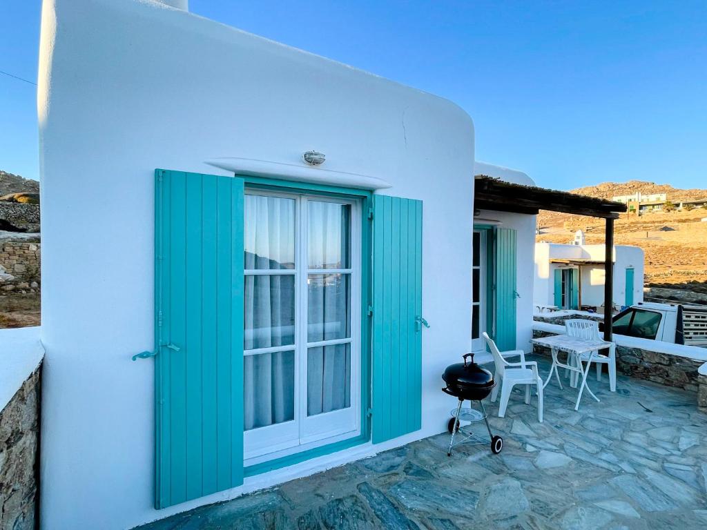 a house with a green door and a patio at Twins Apartments in Fanari