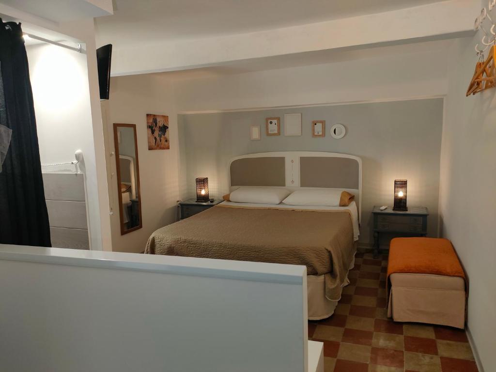 a small bedroom with a bed and a bathroom at essential in Palermo