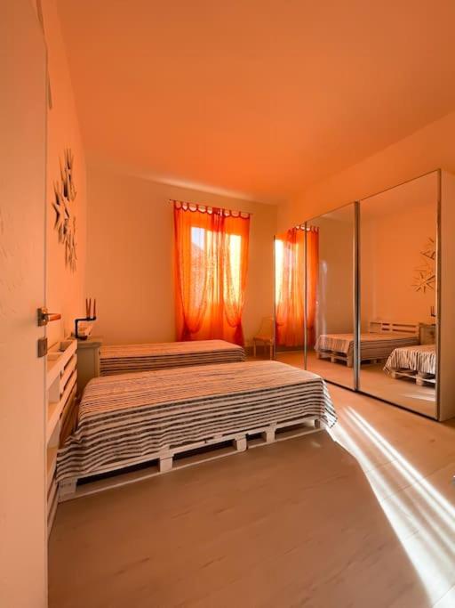 a bedroom with a bed and a large mirror at Bau!House in Piombino