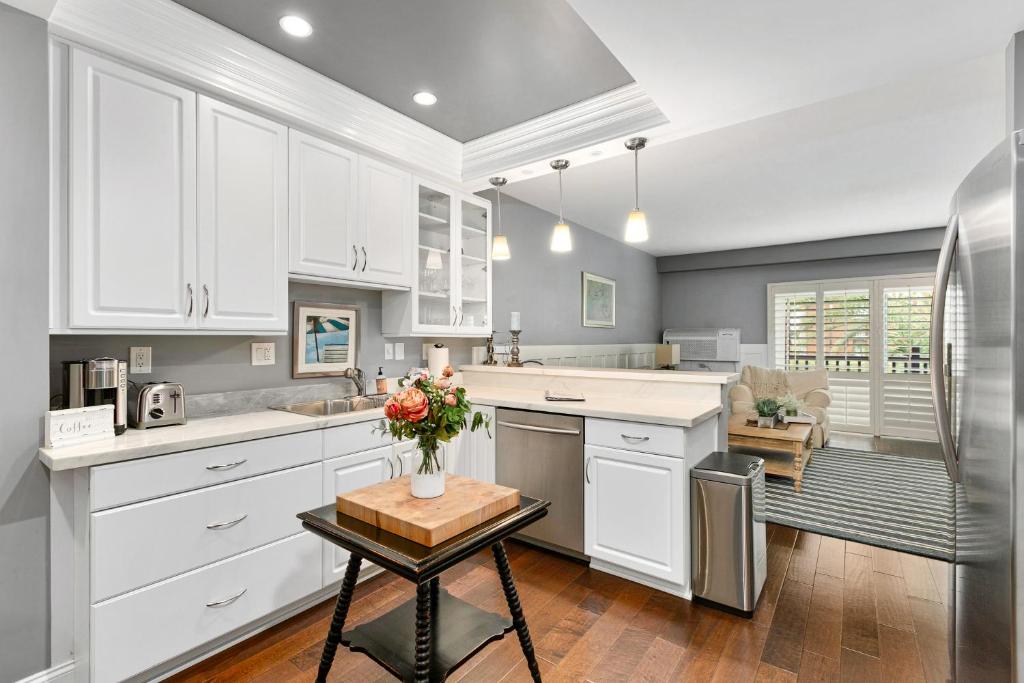 a kitchen with white cabinets and a table at 689 - Steps to the Resort, Peaceful Studio with free Wifi & Parking in Encinitas