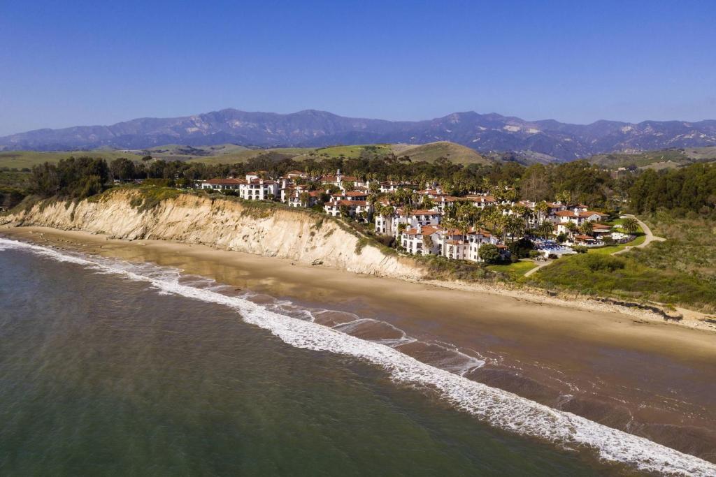 an aerial view of a beach with houses on a cliff at The Ritz-Carlton Bacara, Santa Barbara in Santa Barbara