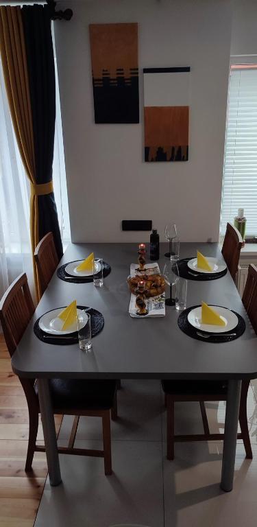 a dining room table with plates of food on it at Cosy Apartment in City Center in Liepāja