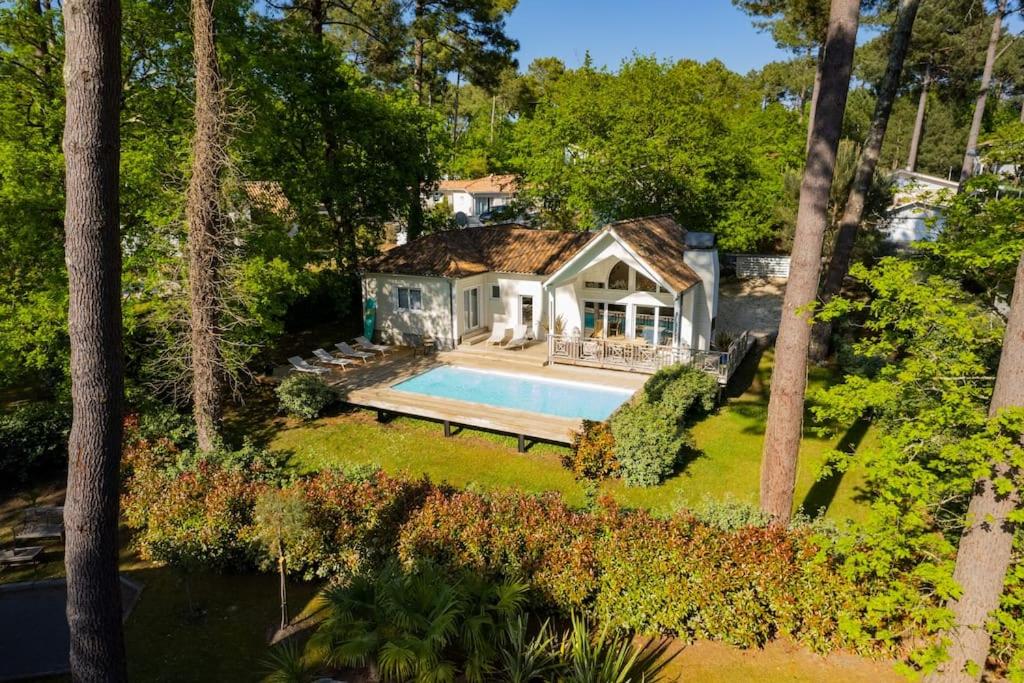 une vue aérienne d'une maison avec piscine dans l'établissement Villa calme du golf avec piscine proche du lac, à Biscarrosse