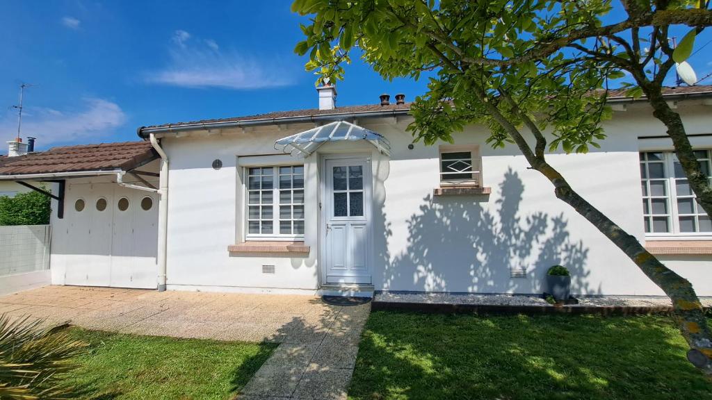 una casa bianca con una porta blu di La Villa Pop a Joué-lés-Tours